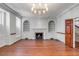 Cozy living room with hardwood floors, fireplace with decorative tile, and built-in shelves at 61 Tradd St, Charleston, SC 29401