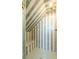 Modern shower with decorative green and white striped tile, marble bench, and brass shower head at 61 Tradd St, Charleston, SC 29401
