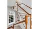Beautiful staircase features wood railings, white balusters, hardwood steps, and natural light at 61 Tradd St, Charleston, SC 29401