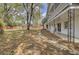 Wide shot of the backyard with an old rock walking path, fencing and decorative wrought iron supports at 703 Canary Dr, Charleston, SC 29414