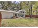 Large green backyard with a wood fence and an open porch with wrought iron supports, lawn at 703 Canary Dr, Charleston, SC 29414