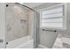 Refreshed bathroom with tiled shower/tub, new fixtures, and a window for natural light at 703 Canary Dr, Charleston, SC 29414