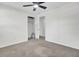 Bright bedroom with neutral carpet, ceiling fan, and a closet with built-in shelving at 703 Canary Dr, Charleston, SC 29414