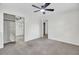 Spacious bedroom with plush carpet, ceiling fan, and mirrored closet doors at 703 Canary Dr, Charleston, SC 29414