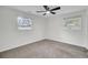 Bright bedroom featuring neutral carpet, ceiling fan, and natural light from two windows at 703 Canary Dr, Charleston, SC 29414