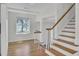 Bright foyer with hardwood floors and a stairway with wooden handrail at 703 Canary Dr, Charleston, SC 29414
