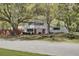 Traditional two-story home with red front doors and black shutters situated on a tree-lined street at 703 Canary Dr, Charleston, SC 29414