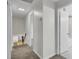 Upstairs hallway with carpet leading to bathroom with glass shower at 703 Canary Dr, Charleston, SC 29414