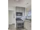 Updated kitchen showcasing modern stainless steel appliances and gray cabinets at 703 Canary Dr, Charleston, SC 29414
