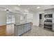 Kitchen with granite countertops, stainless appliances, island, and an open layout to the dining area at 703 Canary Dr, Charleston, SC 29414