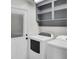 Functional laundry room features modern washer and dryer units, storage cabinets and a door to the outside at 703 Canary Dr, Charleston, SC 29414