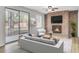 Tastefully staged living room has a fireplace, contemporary flooring, and sliding glass door access to the backyard at 703 Canary Dr, Charleston, SC 29414