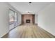 Spacious living room with updated floors, a brick fireplace, and access to a patio through sliding glass doors at 703 Canary Dr, Charleston, SC 29414