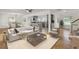 Bright open-concept living room with hardwood floors flowing into a modern kitchen at 703 Canary Dr, Charleston, SC 29414