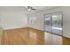 Spacious living area with hardwood floors and sliding door access to outdoor patio at 703 Canary Dr, Charleston, SC 29414