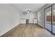 A sunlit room boasts modern flooring, a mini-kitchenette, and a sliding glass door leading to the outdoors at 703 Canary Dr, Charleston, SC 29414