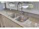 Close-up of a stainless steel kitchen sink with granite countertops and stylish faucet at 703 Canary Dr, Charleston, SC 29414