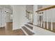 Bright foyer showcasing the staircase with wood and white accents, and hardwood floors at 703 Canary Dr, Charleston, SC 29414