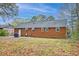 Wide shot of the private backyard featuring a brick home, patio, and plenty of open space at 746 Cartwright Dr, Charleston, SC 29414