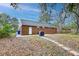 Spacious backyard with a brick home, patio, and mature trees at 746 Cartwright Dr, Charleston, SC 29414
