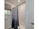 Shower with a bathtub featuring a marble-look tiled wall with a gray shower curtain at 746 Cartwright Dr, Charleston, SC 29414