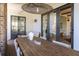 Relaxing covered back porch with wood dining table and modern decor, perfect for gatherings at 772 Post Oak Dr, Mount Pleasant, SC 29464