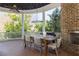 Covered porch with ceiling fan, fireplace, and dining area at 772 Post Oak Dr, Mount Pleasant, SC 29464