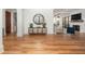 Elegant entryway featuring wood floors, a console table with round mirror, and seamless access to adjacent spaces at 772 Post Oak Dr, Mount Pleasant, SC 29464