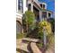 Attractive multi-story home with a brick foundation, curved porch, iron railings, and manicured landscaping at 772 Post Oak Dr, Mount Pleasant, SC 29464