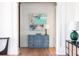 Stylish hallway with hardwood floors, white trim, and a charming blue accent cabinet at 772 Post Oak Dr, Mount Pleasant, SC 29464