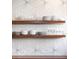 Close-up of kitchen backsplash with designer tile, wood shelves, glassware, and dishware at 772 Post Oak Dr, Mount Pleasant, SC 29464