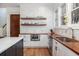 Kitchen features modern appliances, stylish backsplash, wood countertops, and floating shelves at 772 Post Oak Dr, Mount Pleasant, SC 29464