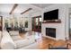 Comfortable living room with fireplace and large windows to covered porch and dining area at 772 Post Oak Dr, Mount Pleasant, SC 29464