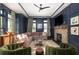 Sophisticated living room with navy walls, fireplace, large windows, and stylish furnishings at 772 Post Oak Dr, Mount Pleasant, SC 29464