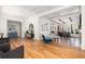 Spacious living room with light hardwood floors and modern decor leading into open kitchen at 772 Post Oak Dr, Mount Pleasant, SC 29464