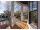 Inviting outdoor porch featuring classic white columns, black railing and a stained wooden floor at 772 Post Oak Dr, Mount Pleasant, SC 29464
