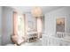 Bright Bedroom with pink accents, decorative chandelier, and white changing table and crib at 780 Clay Field Trl, Summerville, SC 29485