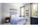 Nautical bedroom featuring a striped headboard and pale blue accent wall with wood canoe art at 780 Clay Field Trl, Summerville, SC 29485