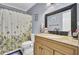Bathroom featuring updated vanity, granite counters, sink, toilet, and shower with floral shower curtain at 7940 Parklane Ct # F, North Charleston, SC 29418