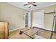 Neutral bedroom featuring a ceiling fan, double closet, and doorway leading to an adjoining space at 7940 Parklane Ct # F, North Charleston, SC 29418