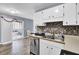 Bright kitchen area with stainless steel appliances, white cabinets, and view to dining area and backyard at 7940 Parklane Ct # F, North Charleston, SC 29418