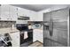 Updated kitchen features stainless steel appliances, white cabinets, wood trim counters, and mosaic backsplash at 7940 Parklane Ct # F, North Charleston, SC 29418