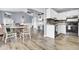 Open-concept living area features light wood flooring, neutral paint colors, and updated kitchen with stainless steel appliances at 7940 Parklane Ct # F, North Charleston, SC 29418