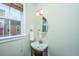 Powder room features a wood vanity with an oval mirror and a hanging white towel at 835 Hale St, Charleston, SC 29412