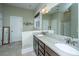 Large bathroom featuring double sinks, granite countertop, walk-in shower, and plenty of storage space at 835 Hale St, Charleston, SC 29412