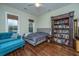 Bright bedroom features a blue couch, and a custom bookshelf, providing a cozy and functional space at 835 Hale St, Charleston, SC 29412