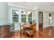Cozy dining area featuring a round wooden table and backyard views through bright windows at 835 Hale St, Charleston, SC 29412