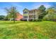 Lovely two-story home with a double porch and vibrant green lawn, showcasing curb appeal at 835 Hale St, Charleston, SC 29412