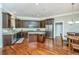 Open concept kitchen with stainless steel appliances, central island, and seamless integration to a dining area at 835 Hale St, Charleston, SC 29412