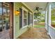 Inviting front porch featuring a ceiling fan, column supports, and well-maintained exterior at 835 Hale St, Charleston, SC 29412